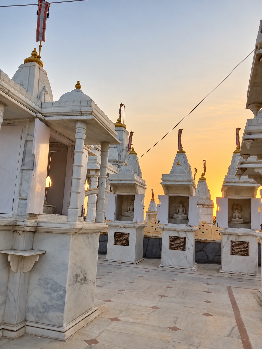 सूर्यास्त में 108 आदिनाथ की शिखरबद्ध देहरियाँ — the shikhara-crowned shrines of the 108 Adinath at sunset